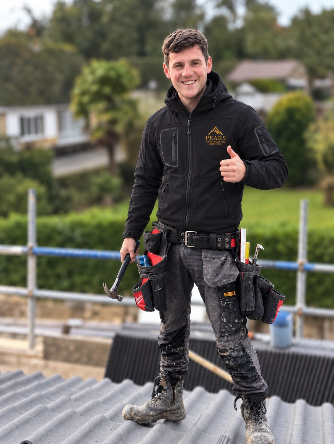 Danny smiling on site in his workwear and tool belt